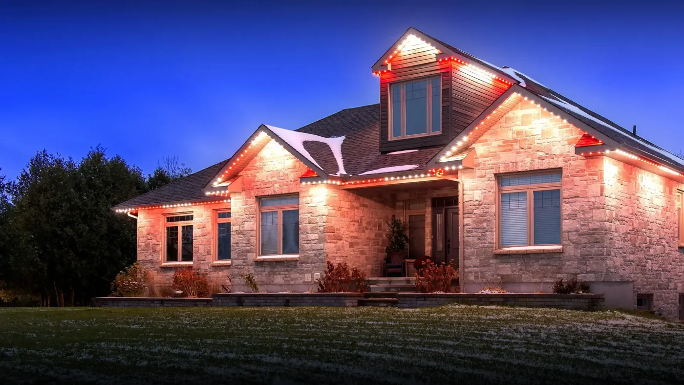 Red-and-white Celebright lighting on a brick home
